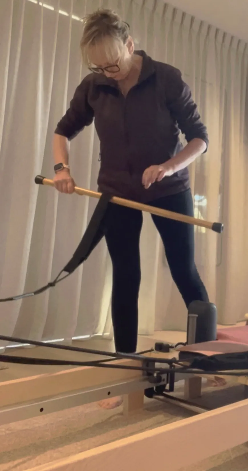 Andrea setting up the reformer with a pole and strap